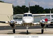 stock-photo-a-new-white-and-silver-twin-prop-plane-at-a-local-airport-43852009.jpg